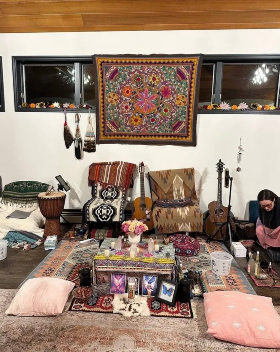 Sacred ceremony space with tapestry, instruments, crystals, and altar