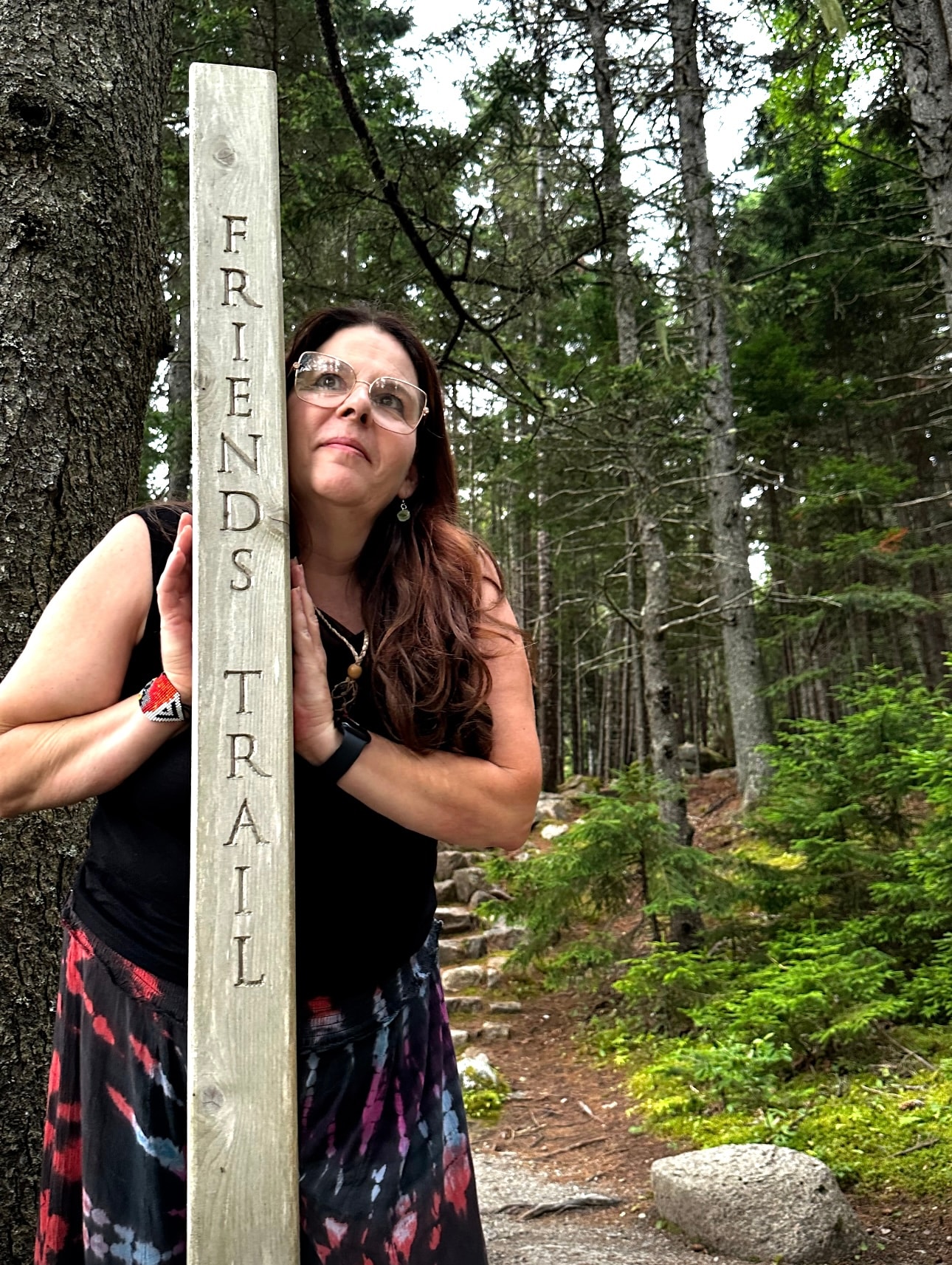 Angela at the Friends Trail forest marker